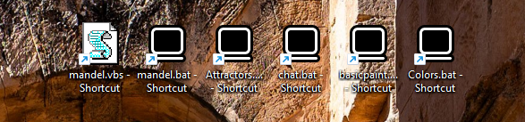 A row of Windows desktop shortcuts — mandel.vbs, mandel.bat, Attractors, chat.bat, basicpaint and Colors.bat — each launching a BASIC256 program directly